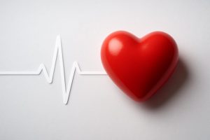 Red heart symbol next to a heartbeat line on a white background